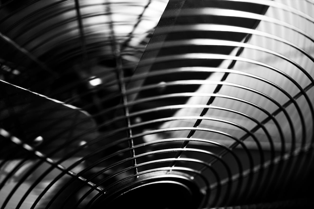 Black and white macro shot of industrial fan blades with abstract patterns.
